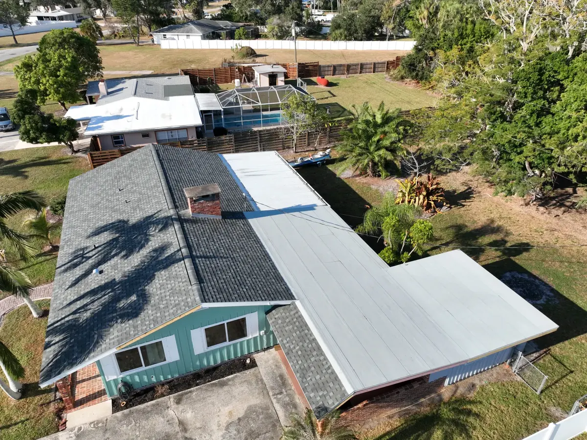 Multi-system roof aerial view showing shingle and metal sections, November 2025