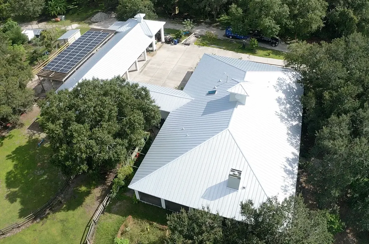 Standing seam metal roof, wide aerial view, country estate