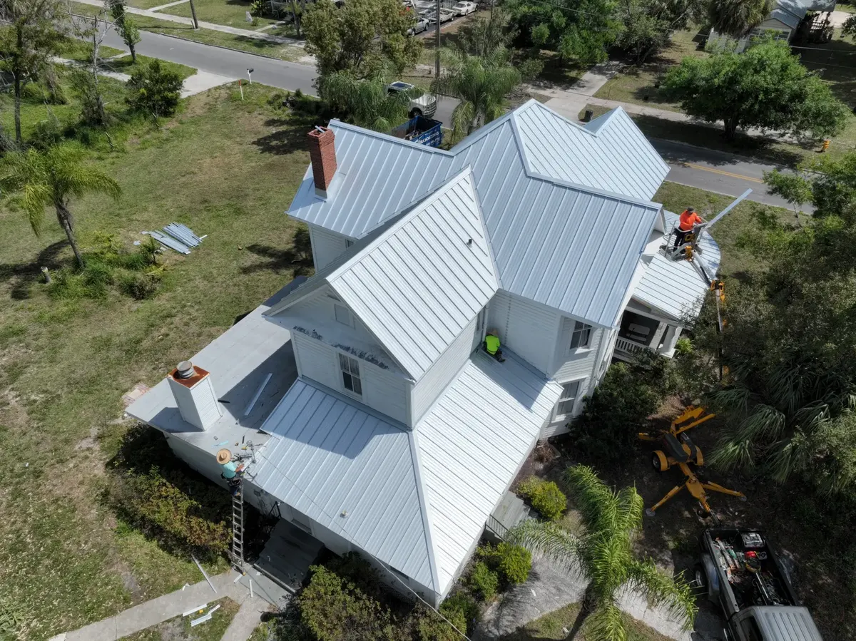 Standing seam metal roof installation in progress, March 2024
