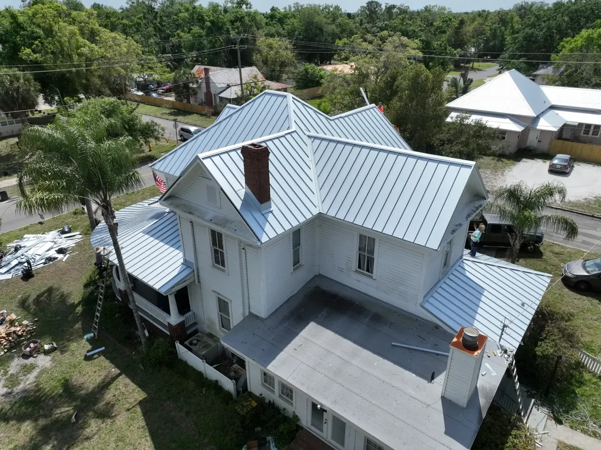 Standing seam metal roof installation in progress, March 2024