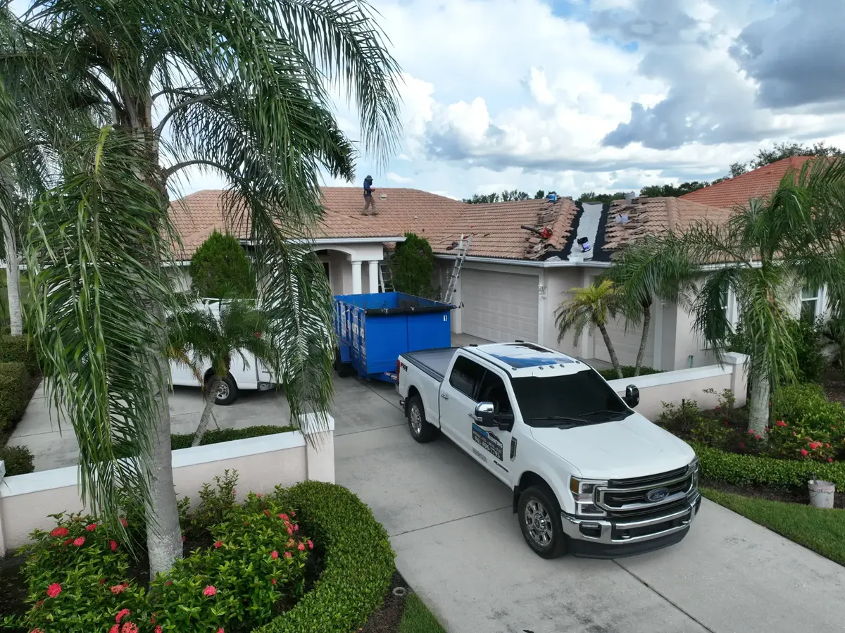 Coastline Roofing truck at tile reroof job, aerial view, Manatee County